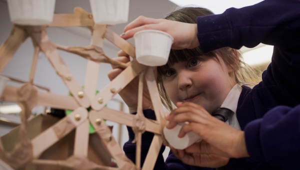 girl building a micro:bit controlled ferris wheel